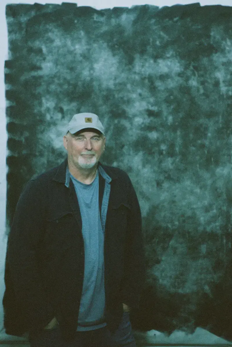 Dennis Hood in front of green background
